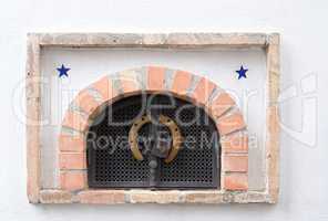 Small ventilation window with grate, padlock and horseshoe