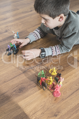 Child playing with small toys