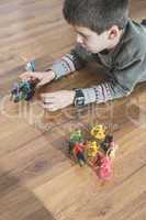 Child playing with small toys