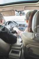  Young boy and girl driving a car