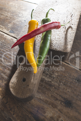 Hot peppers on wooden cutting board