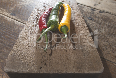 Hot peppers on wooden cutting board