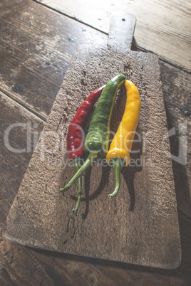 Hot peppers on wooden cutting board