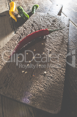 Hot peppers on wooden cutting board