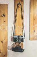 Vintage photo camera hooked on the wall