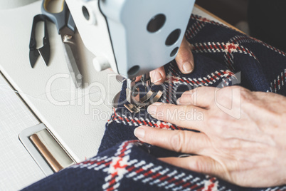 Woman sewing on a sewing machine.