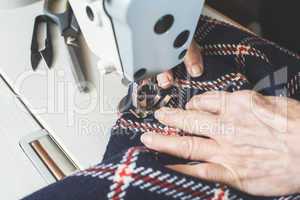 Woman sewing on a sewing machine.