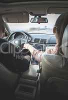  Young boy and girl driving a car