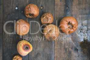 Rotten apples on wood