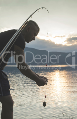 Man on fishing with rod.