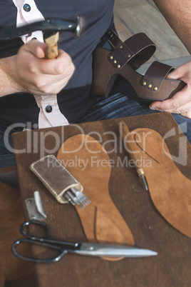 Hands making shoes