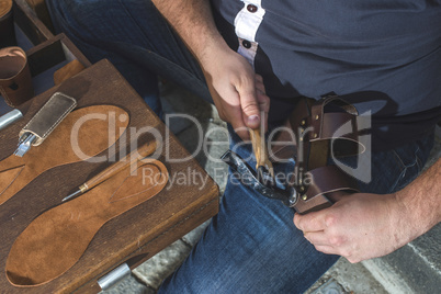 Hands making shoes