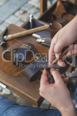 Hands making shoes