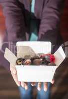 Hands holding a box of chocolates