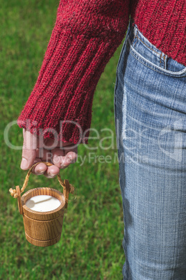 Vintage small wooden mug of milk