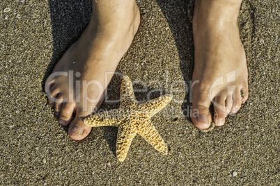 Starfish and feet on the beach Starfish and feet on the beach