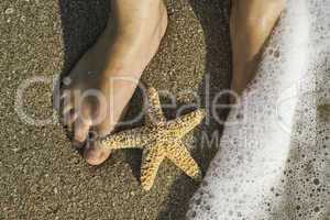 Starfish and feet on the beach