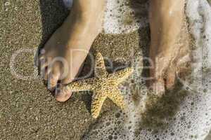 Starfish and feet on the beach