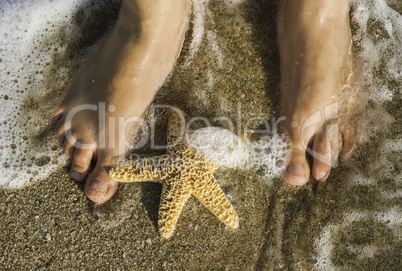 Starfish and feet on the beach