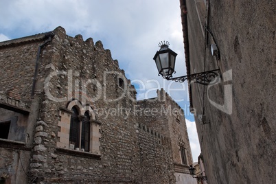 Retro street lantern in Medieval center of Taormina, Italy, on cloudy day