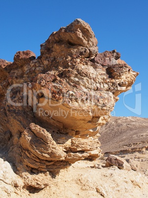 Scenic stratified orange rock in stone desert, Israel