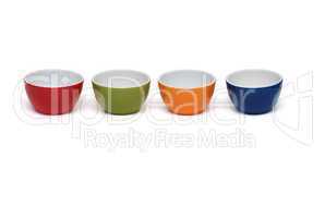 Row of four porcelain bowls isolated on white background