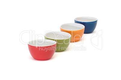 Diagonal row of four porcelain bowls isolated on white background