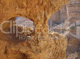 Window in the orange sandstone rock in stone desert, Israel