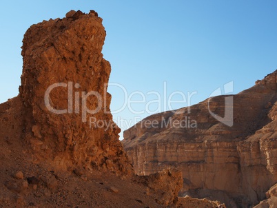 Scenic pillar rock in a stone desert at sunset