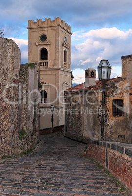 Paved medieval street with church belfry in Savoca village, Sicily, Italy