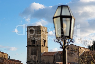 Medieval church and street lantern in Savoca village in Sicily, Italy, at sunset