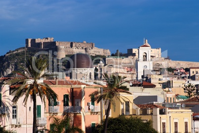 View from sea of Milazzo town in Sicily, Italy, with medieval castle on hilltop