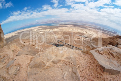 Fisheye view of desert landscape under Masada fortress near the Dead Sea