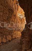 Narrow slot between two rocks in desert canyon