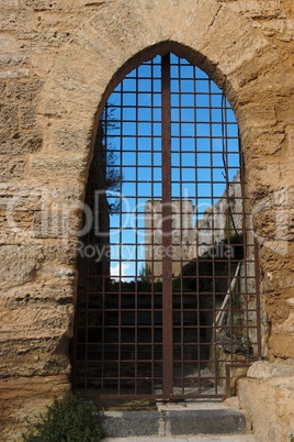 Barred gate off Castello di Lombardia medieval castle in Enna, Sicily, Italy