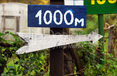 Rustic wooden road direction sign