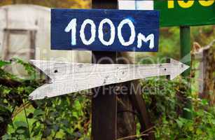 Rustic wooden road direction sign