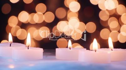 close-up burning candle and christmas lights seamless loop