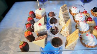 a variety of pastries on a glass stand