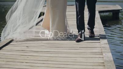 Wedding couple - view from the bottom , legs, go over the bridge