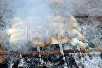 fried pieces of lard cooking on the fire