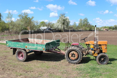 old tractor with trailer in the village