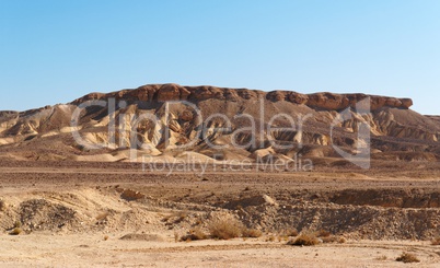 Scenic weathered yellow hill in stone desert