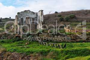 Farmhouse ruin among rural landscape