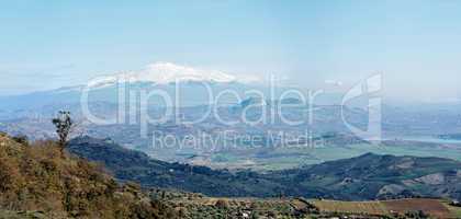 Sicilian rural landscape in winter with snow peak of Etna volcano in Italy