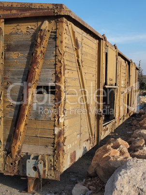 Abandoned wooden railway car on props