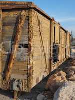 Abandoned wooden railway car on props
