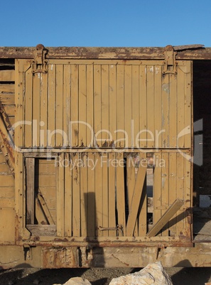Broken door of abandoned wooden railway car