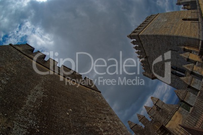 Fisheye view of towers of Almodovar del Rio medieval castle against the cloudy sky