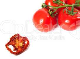 Bunch of raw tomatoes with water drops and dried slice